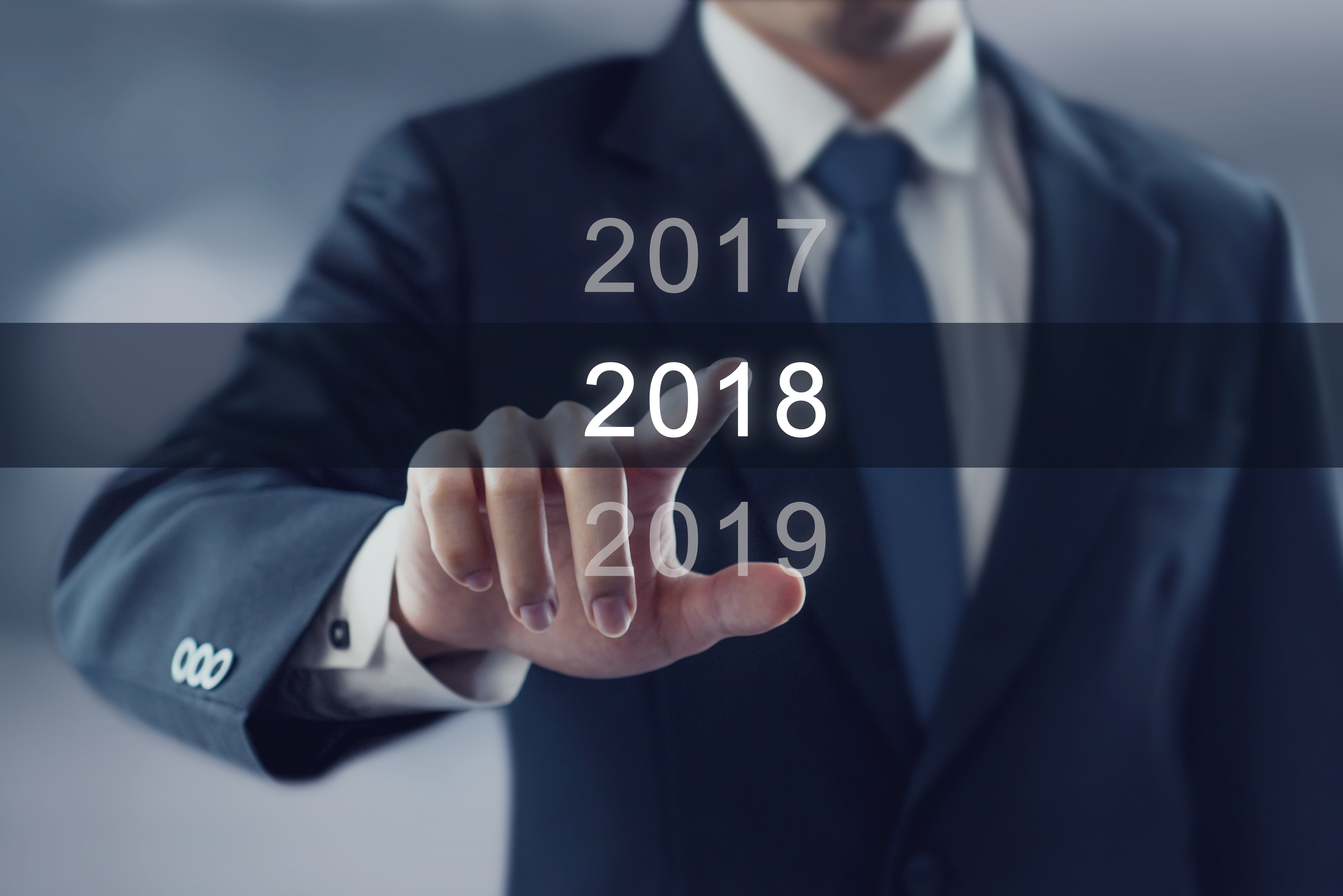 Businessman pointing year 2018. Business new year card concept.